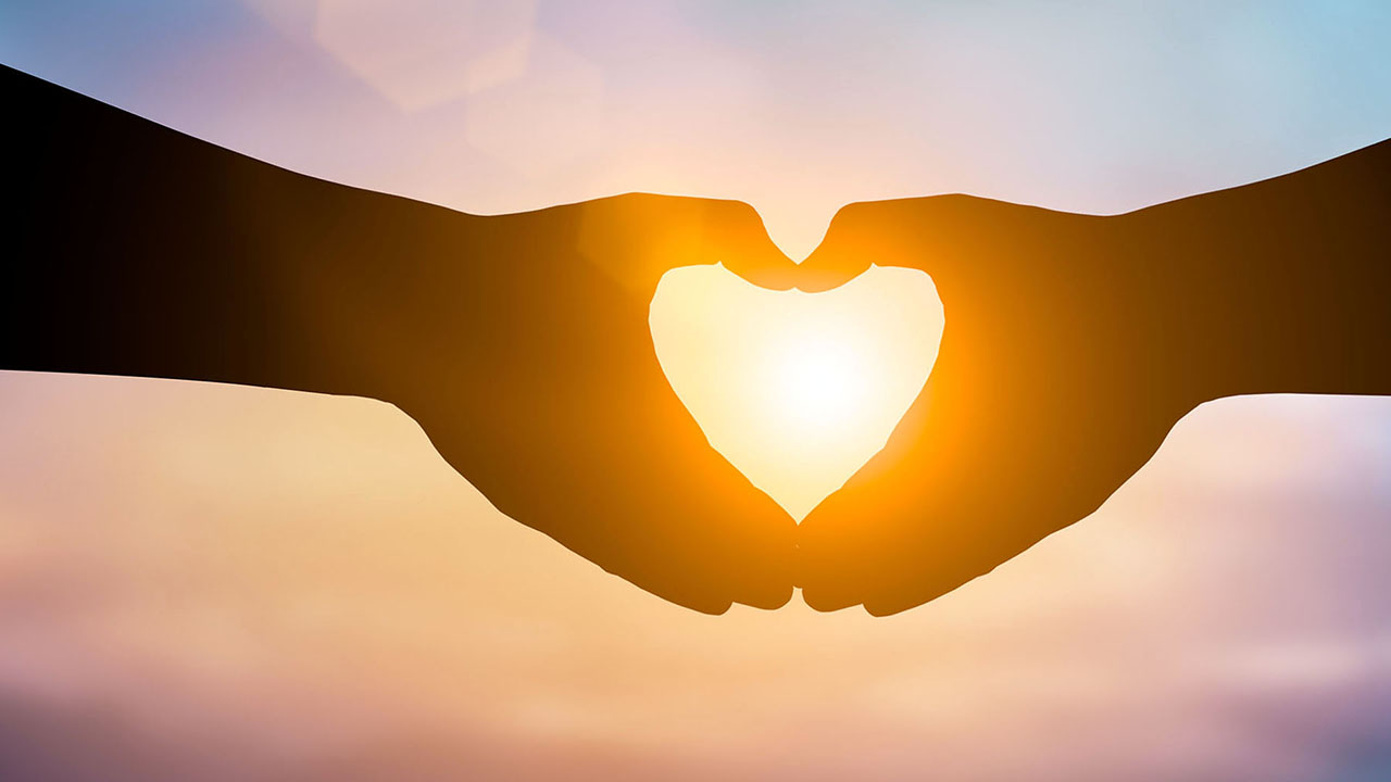 Loving hands shaped together as a heart image.