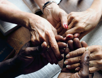 People holding hands during a prayer