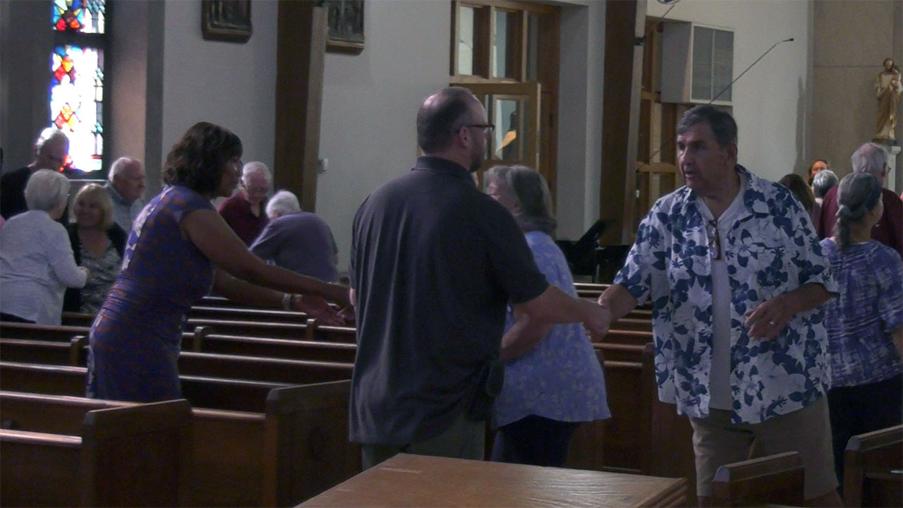 Mass attendees welcoming each other at St. Therese Little Flower Parish.