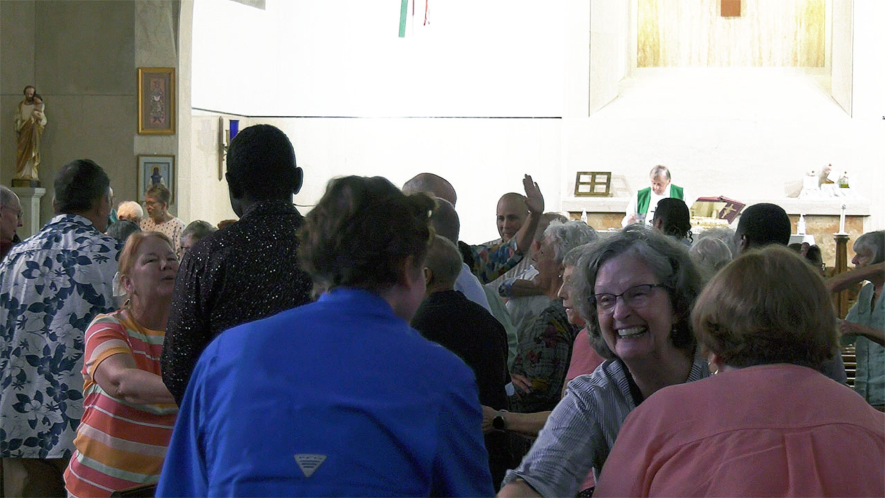 Mass attendees greeting each other at St Therese Little Flower Parish
